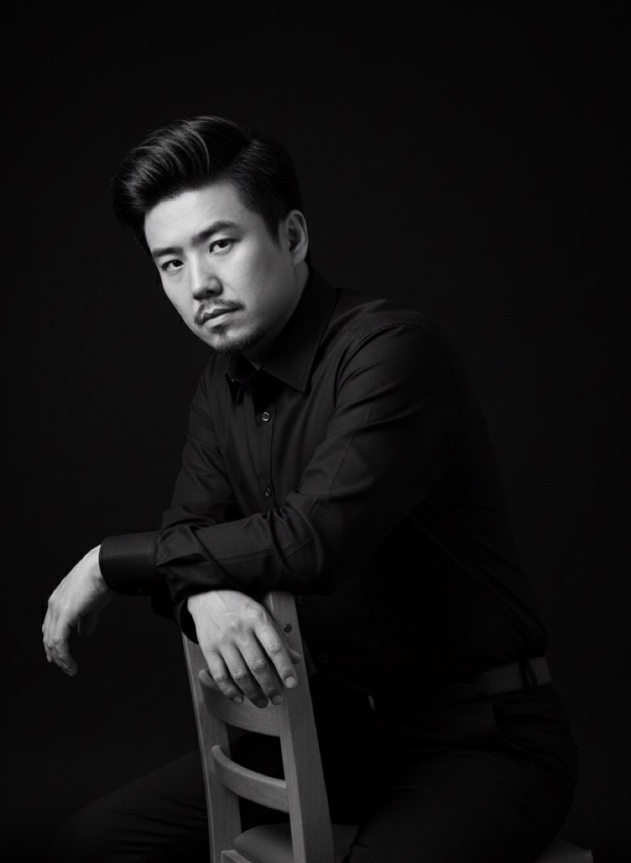 Wang Yongzhi seated in a dark jacket